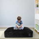 Soft black crash pad filled with foam blocks, perfect for sensory play and safe impact absorption for children.