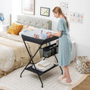 Folding baby change table in black with storage basket and shelf, designed for easy diaper changes and convenience.
