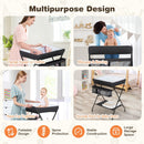 Folding baby change table in black with storage basket, designed for easy diaper changes and back support for parents.