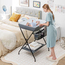 Folding baby change table in grey with storage basket and shelf, designed for convenient diaper changes and infant care.