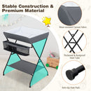 Folding baby change table in grey with storage basket and shelf, featuring stable steel frame and waterproof canvas.