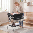 Baby changing table in black with storage bag and shelf, adjustable height, and secure design for newborns and infants.
