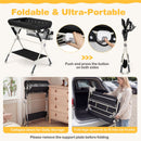 Baby changing table in black with storage bag and shelf, foldable design for easy transport and storage.