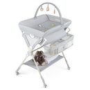 Baby changing table in grey with raised edges and toy rack, designed for safety and convenience during diaper changes.