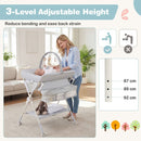 Baby changing table in grey with adjustable height, storage bag, and shelf for convenient diapering and care.