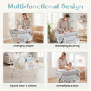 Baby changing table in grey with storage bag, height-adjustable, and waterproof surface for easy cleaning and safety.