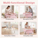 Baby changing table in pink with storage bag, adjustable height, and drying rack for newborn care and convenience.