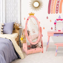Freestanding pink dressing mirror with 360° rotatable design, storage shelf, and crown detail for kids' rooms.