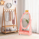 Freestanding pink kids dressing mirror with 360° rotatable design, storage shelf, and crown detail for playful decor.