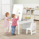 Kids art table set with 2 chairs, paper roll, and storage baskets, perfect for creative play in daycare or playroom.