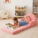 Kids flip out sofa in pink with plush teddy fleece cover, perfect for reading and relaxing in playroom.