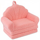 Pink 2-in-1 kids flip-out sofa with plush teddy fleece cover, shell-shaped backrest, and carry handle for playroom use.