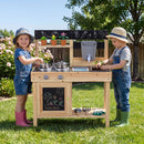 Children playing with the outdoor wooden mud kitchen