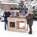 Children using the outdoor mud kitchen