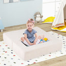 Modular kids sofa couch in beige, designed for versatile play, featuring a child sitting with colorful balls for.