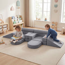 Modular kids play couch in grey, featuring 10 soft blocks for creative play, climbing, and lounging in a playroom.