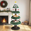 Multi-level green Christmas cat tree with red accents, plush cushions, and dangling toys for festive feline fun.
