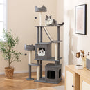 Tall grey cat tree with multiple levels, condos, and scratching posts for indoor cats, enhancing home decor.