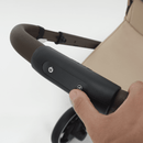 Close-up of a finger operating the e-Gazelle S electronic rocking-function button on the handlebar.