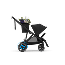Moon Black e-Gazelle S with one seat and the included shopper basket carrying flowers. Flowers shown for illustration.