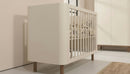 Kenva Cot — side detail in a nursery