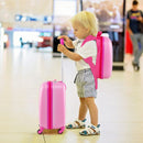Child using a pink 2-piece carry-on luggage set with spinner wheels, including a hardshell suitcase and backpack.