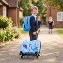 Kid pulling a colorful 18" hardshell suitcase with spinner wheels and a matching backpack for travel adventures.