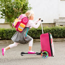 Child riding the pink and white 2-in-1 skateboard luggage with lighted wheels, perfect for outdoor adventures.