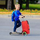 Kid riding the red 2-in-1 skateboard luggage with lighted wheels, perfect for outdoor adventures and travel.