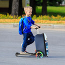 Kid riding a 2-in-1 skateboard luggage with colorful lighted wheels, perfect for outdoor adventures and travel.