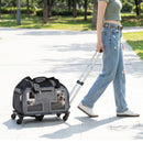 Rolling pet carrier in grey with wheels and padded handle, featuring mesh windows for ventilation and comfort during travel.
