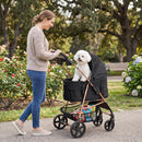 Pet stroller in black with detachable carrier, cup holder, and smooth-rolling wheels for comfortable outdoor use.