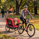 Dog bike trailer in red, featuring breathable mesh windows and removable front wheel, perfect for biking with pets.