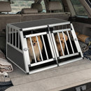Travel dog crate with aluminum frame and dual lockable doors, designed for safe transport of two small dogs in a car.