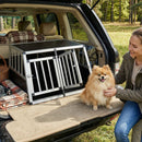 Travel dog crate with lockable doors and removable divider, made from durable aluminum, perfect for safe pet transport.