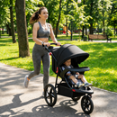 Parent using the Rever Bebe foldable jogger stroller in a park