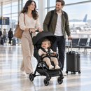 Rever Bebe Joy stroller in black — airport terminal lifestyle scene