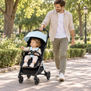 Rever Bebe Joy stroller in blue — park walk lifestyle scene