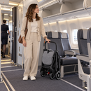 Rever Bebe Joy stroller in dark grey — aircraft cabin lifestyle scene