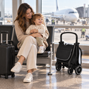 Rever Bebe Joy stroller in grey — airport gate folded lifestyle scene