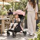 Rever Bebe Joy stroller in pink — cafe terrace lifestyle scene