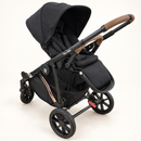 Rever Bebe VEVO Black seat showing the padded harness, canopy, adjustable leg rest and brown bumper bar